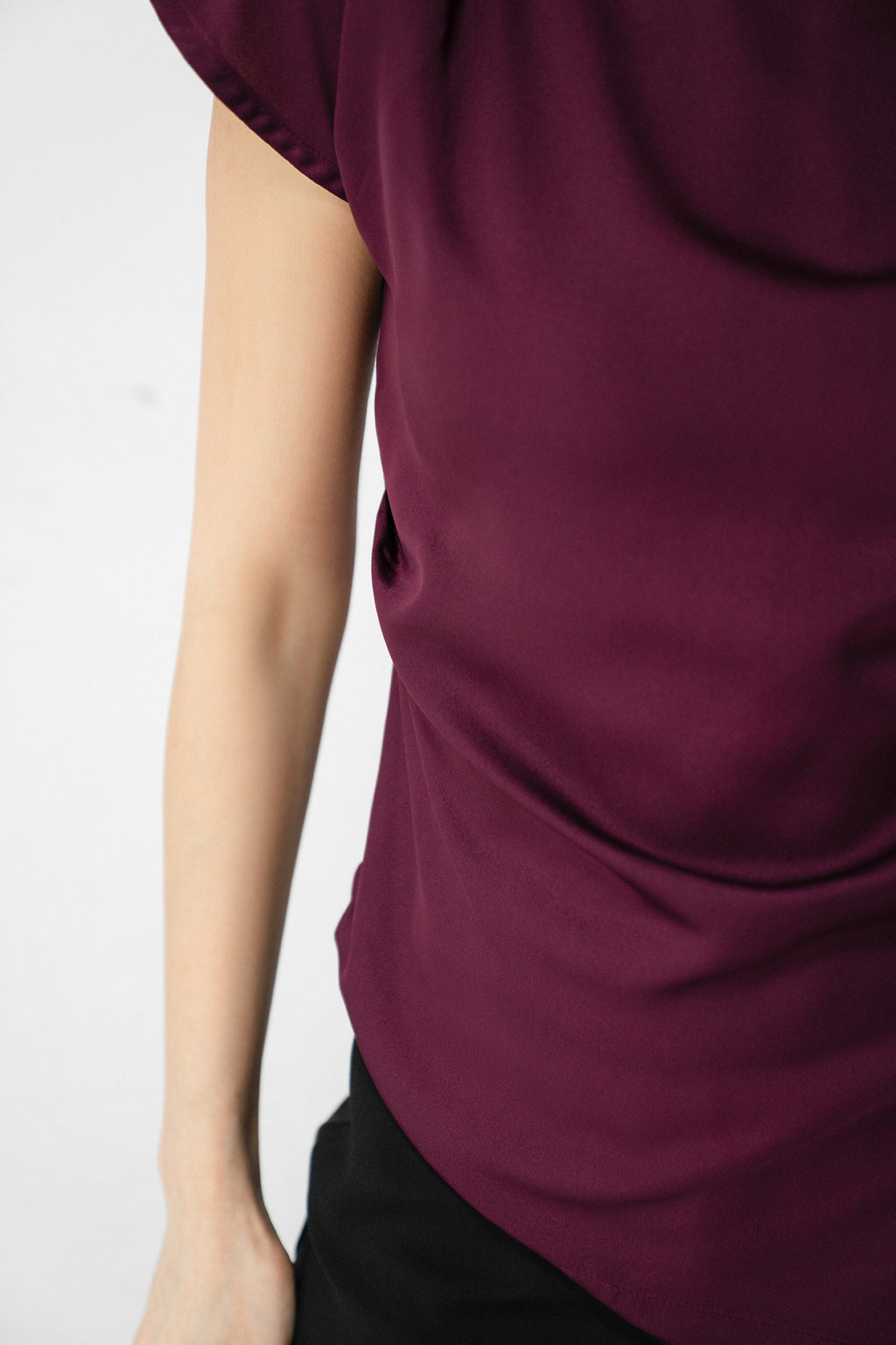 Flat lay of the plum drapped asymmetrical wrap top, by SOLA Pakistan.