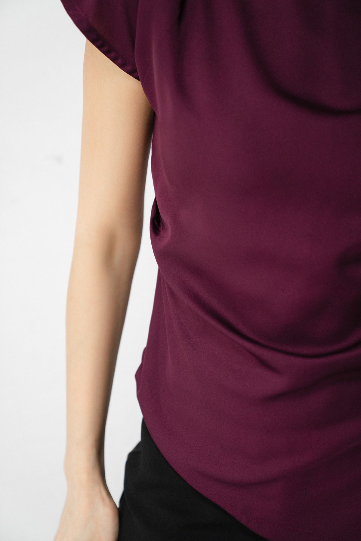 Flat lay of the plum drapped asymmetrical wrap top, by SOLA Pakistan.