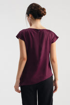 Plum drapped asymmetrical wrap top shown in a styled fit, by SOLA Pakistan.