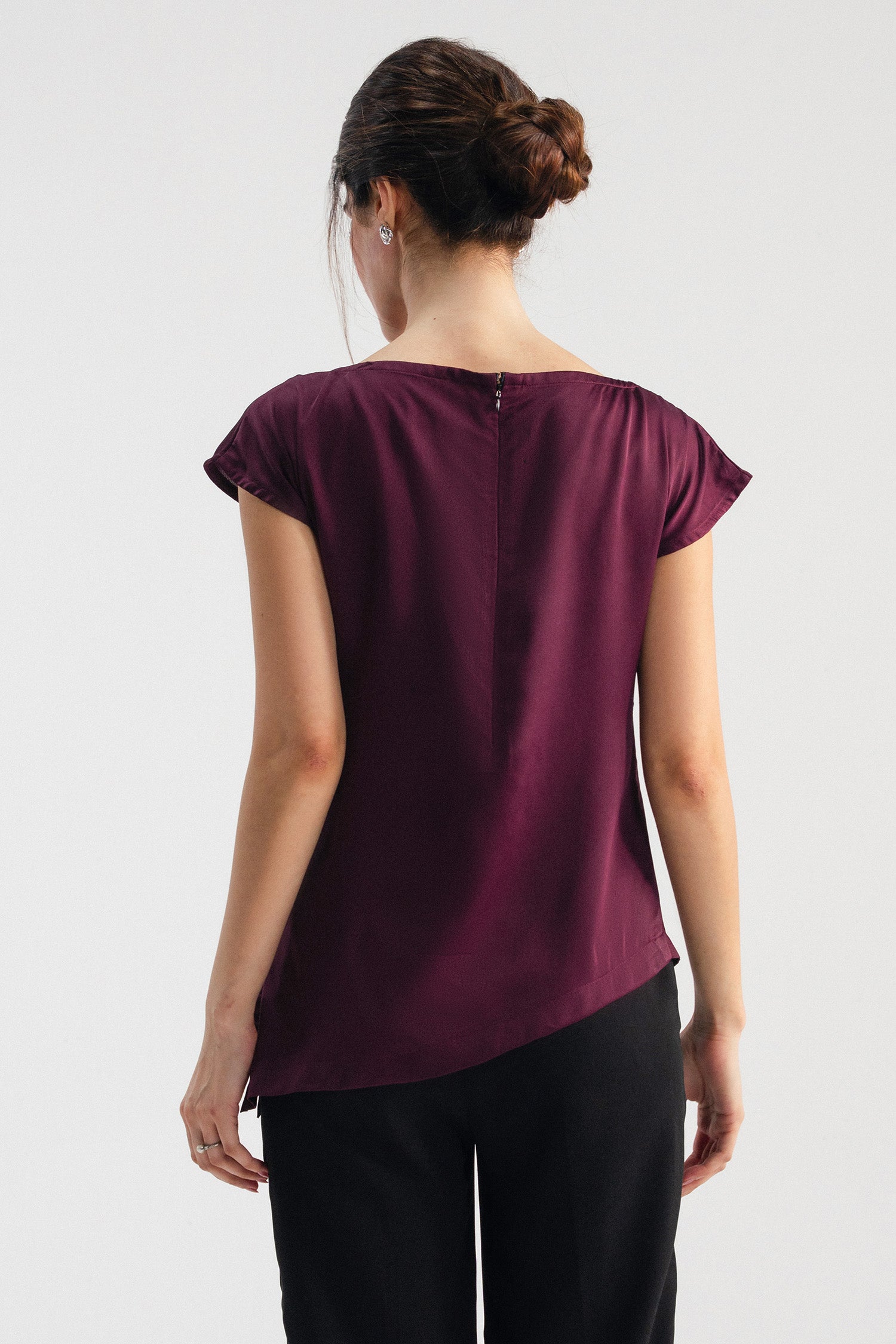 Plum drapped asymmetrical wrap top shown in a styled fit, by SOLA Pakistan.