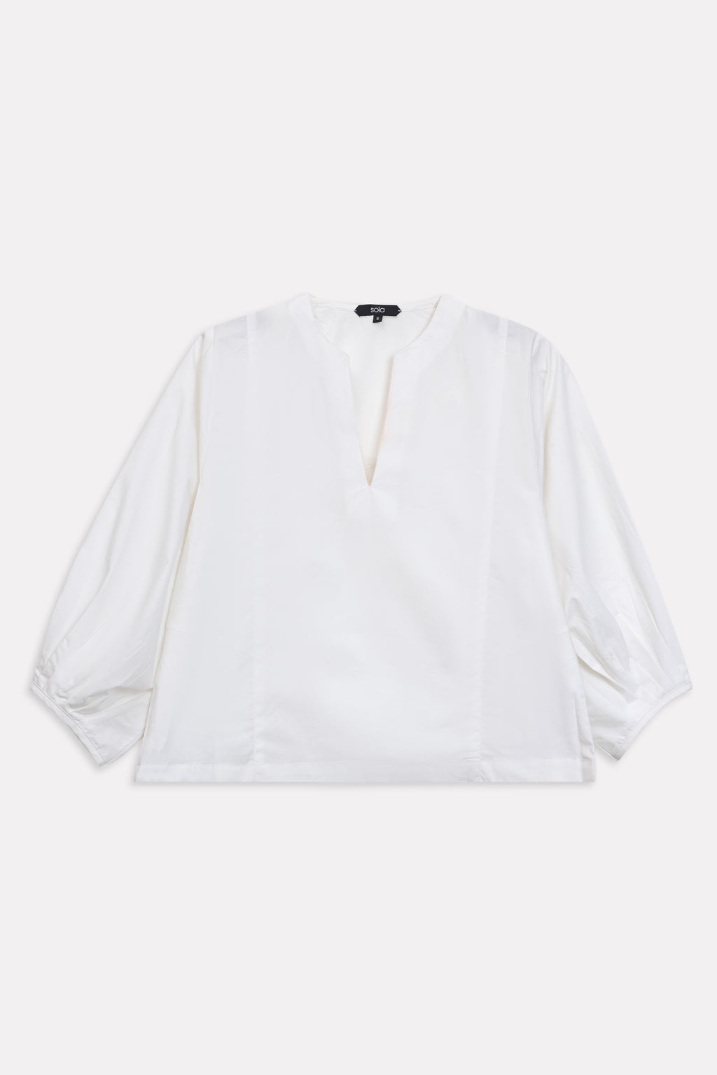 Close-up detail on the white balloon sleeve relaxed top, by SOLA Pakistan.
