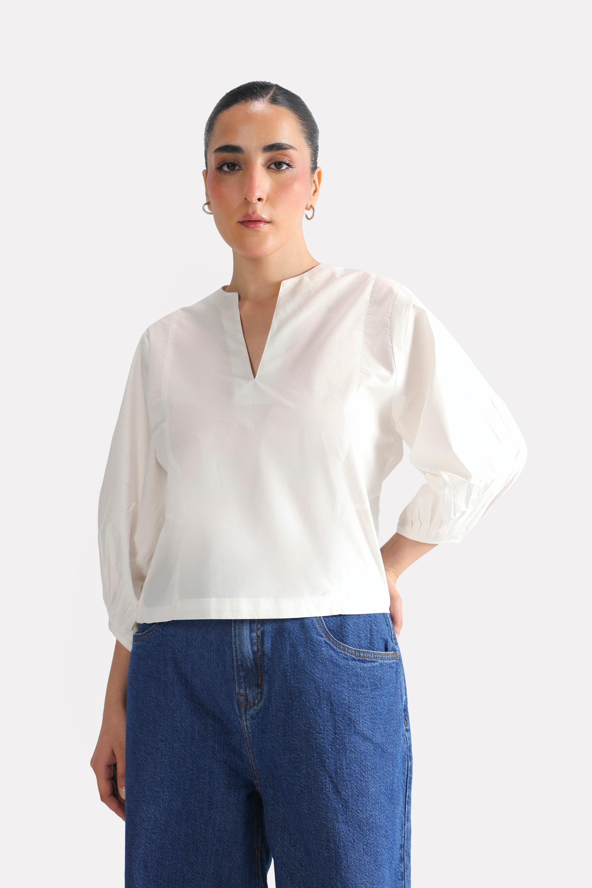 Flat lay of the white balloon sleeve relaxed top, by SOLA Pakistan.