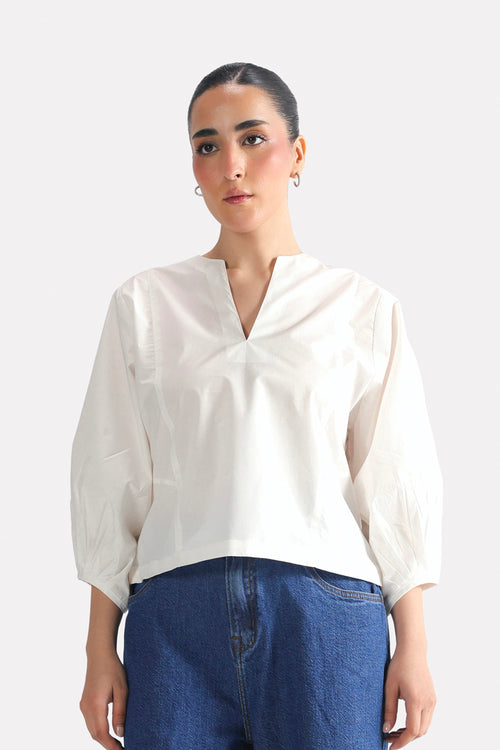 White balloon sleeve relaxed top in cotton-linen blend, worn by a model, by SOLA Pakistan.