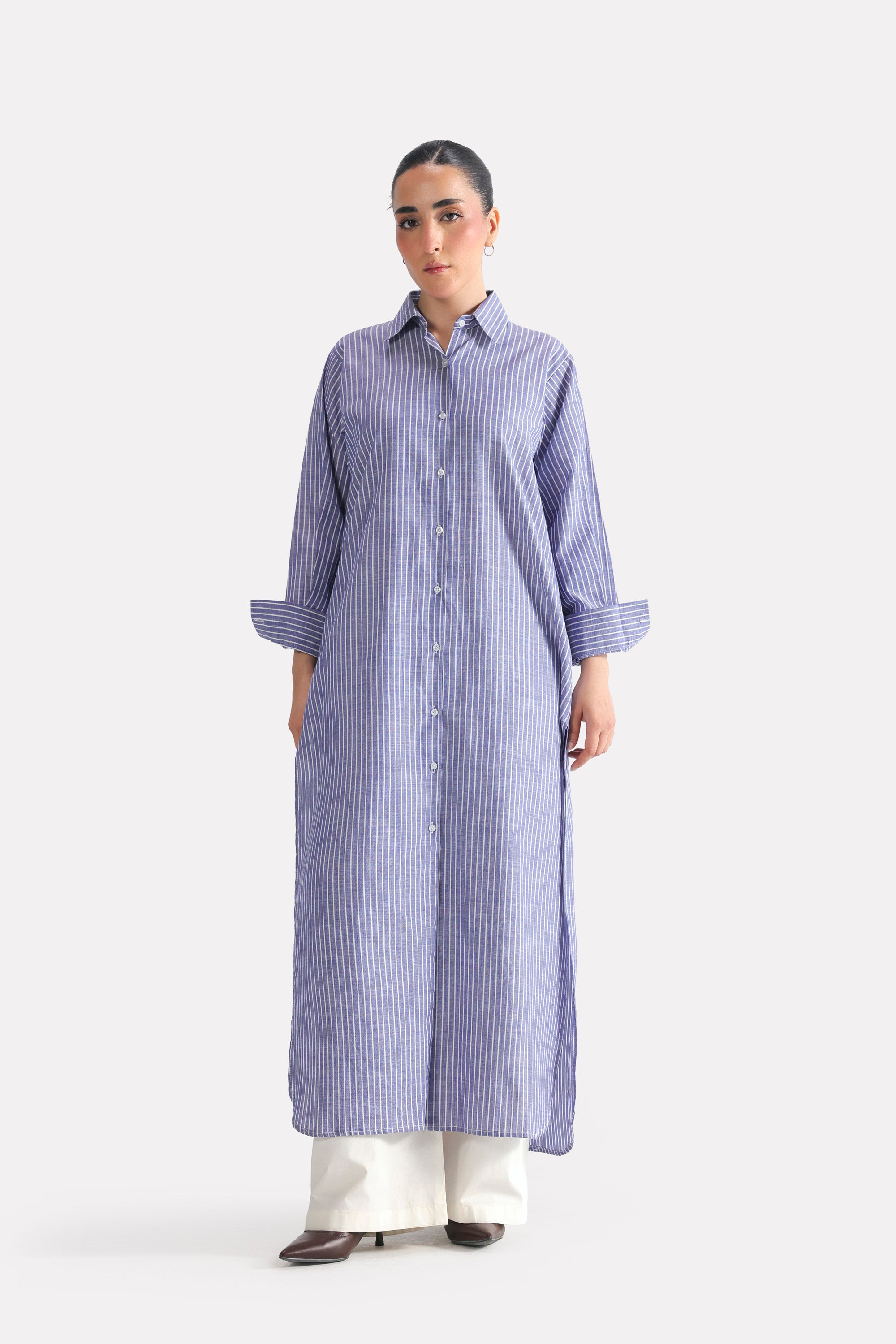 White & blue fit & flare shirt dress in cotton, worn by a model, by SOLA Pakistan.