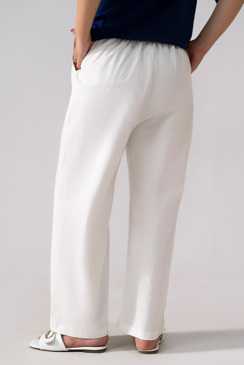 Close-up detail on the white cotton straight trousers, by SOLA Pakistan.