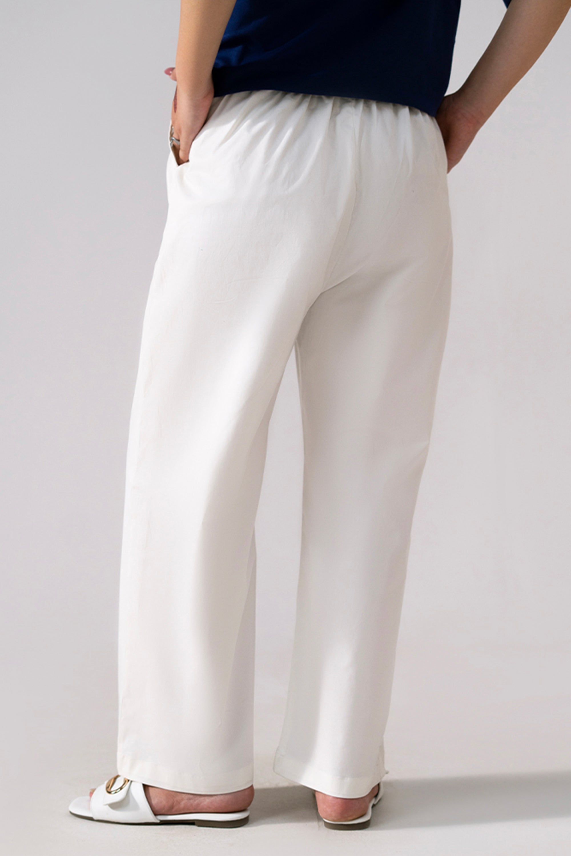 Close-up detail on the white cotton straight trousers, by SOLA Pakistan.