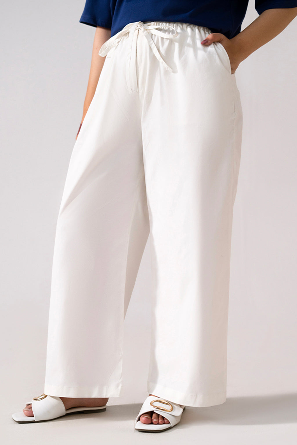 White cotton straight trousers, full styled look, by SOLA Pakistan.