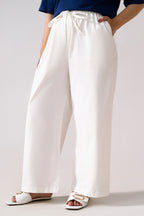 White cotton straight trousers, full styled look, by SOLA Pakistan.