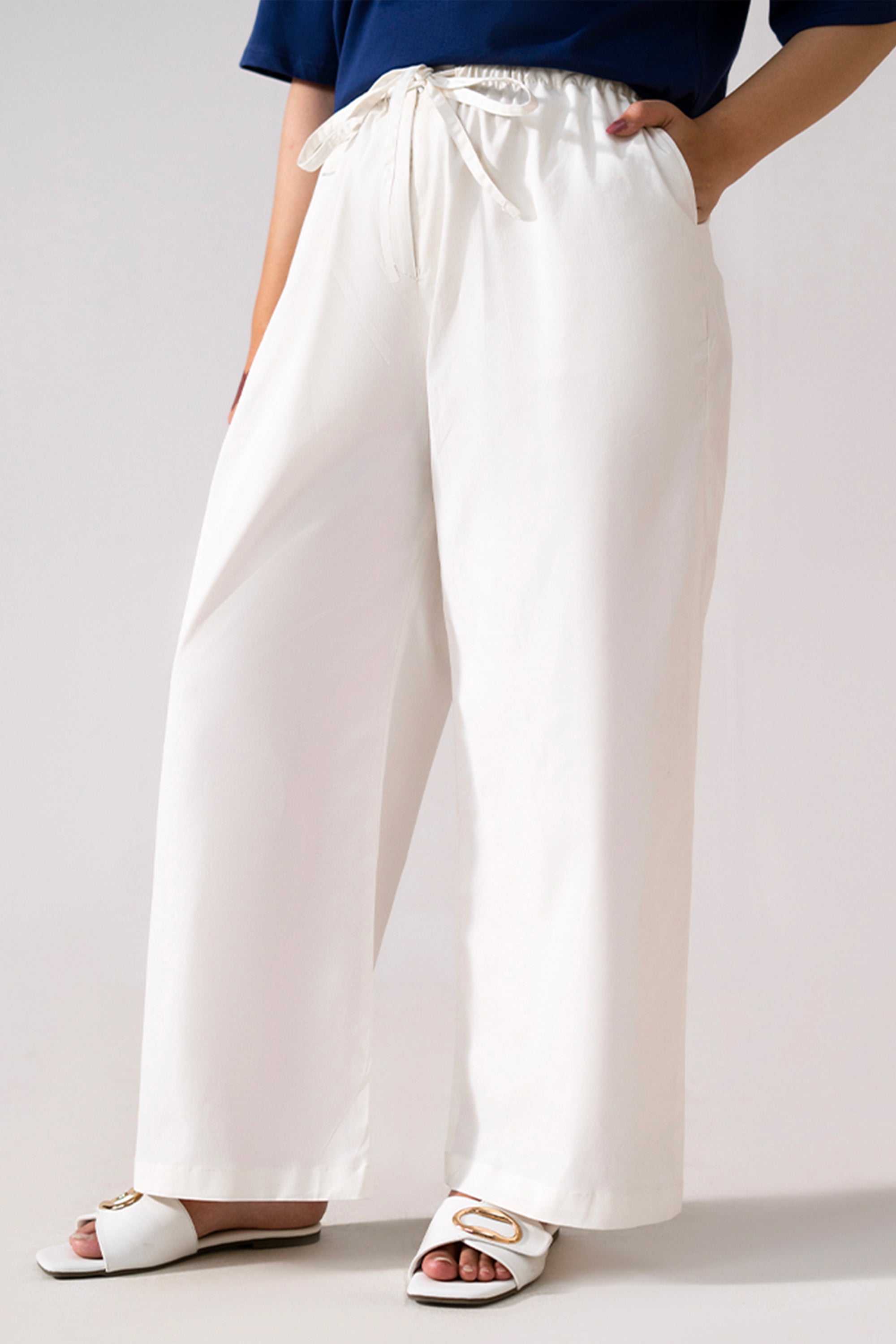 White cotton straight trousers, full styled look, by SOLA Pakistan.