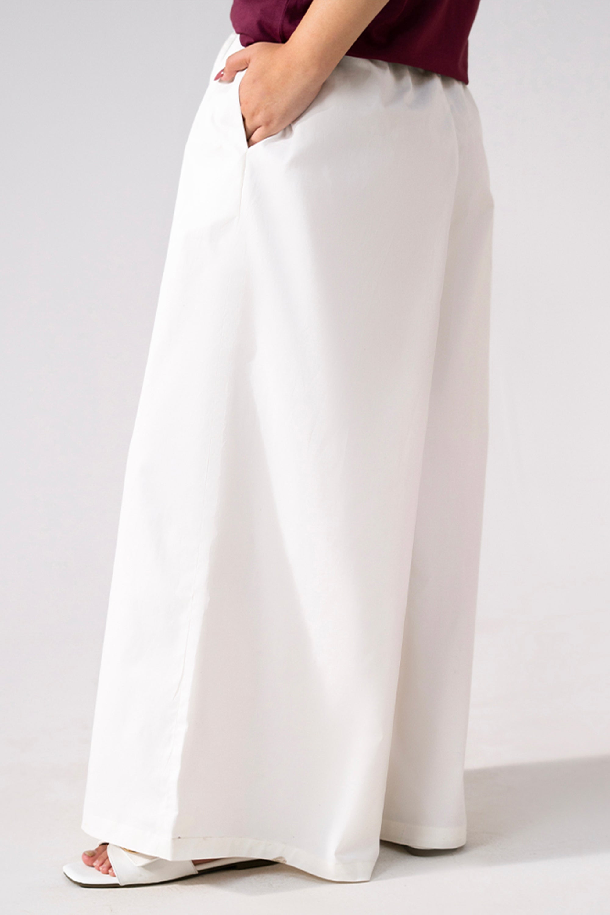 Close-up detail on the white cotton wide trousers, by SOLA Pakistan.