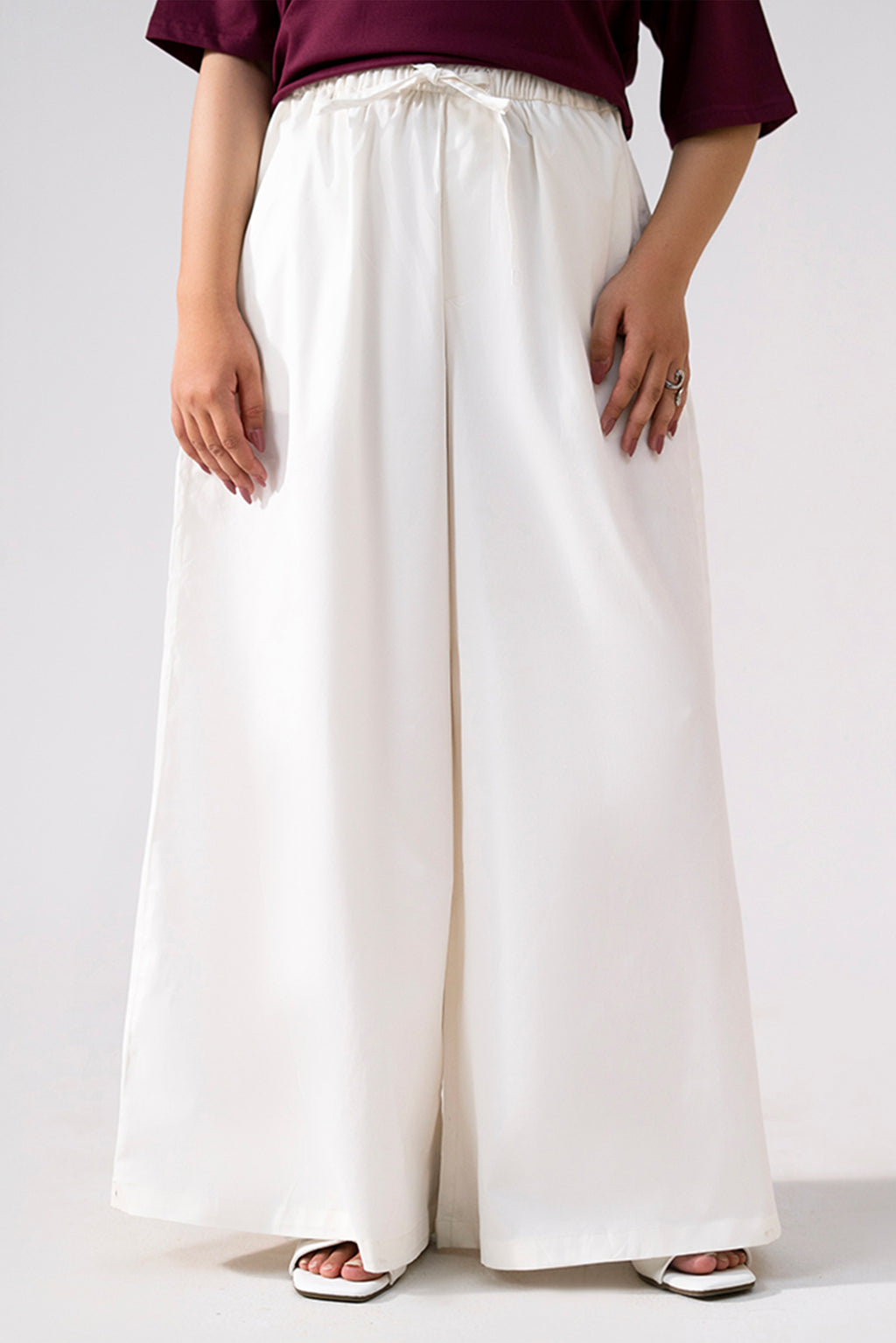 White cotton wide trousers, full styled look, by SOLA Pakistan.