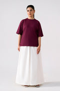 White cotton wide trousers, worn by a model, by SOLA Pakistan.