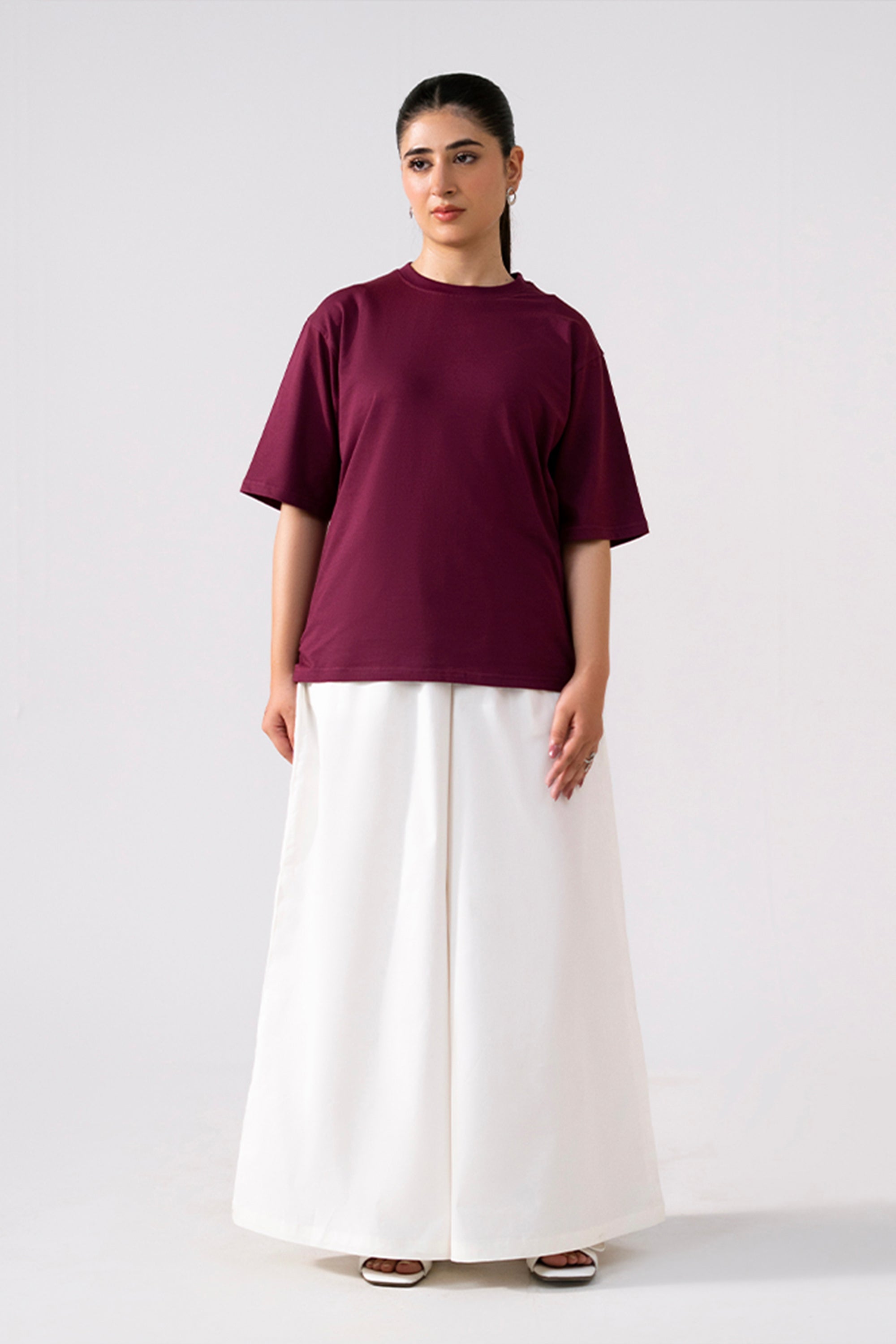 White cotton wide trousers, worn by a model, by SOLA Pakistan.