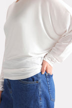 Close-up detail on the white fluid sleeve t-shirt, by SOLA Pakistan.
