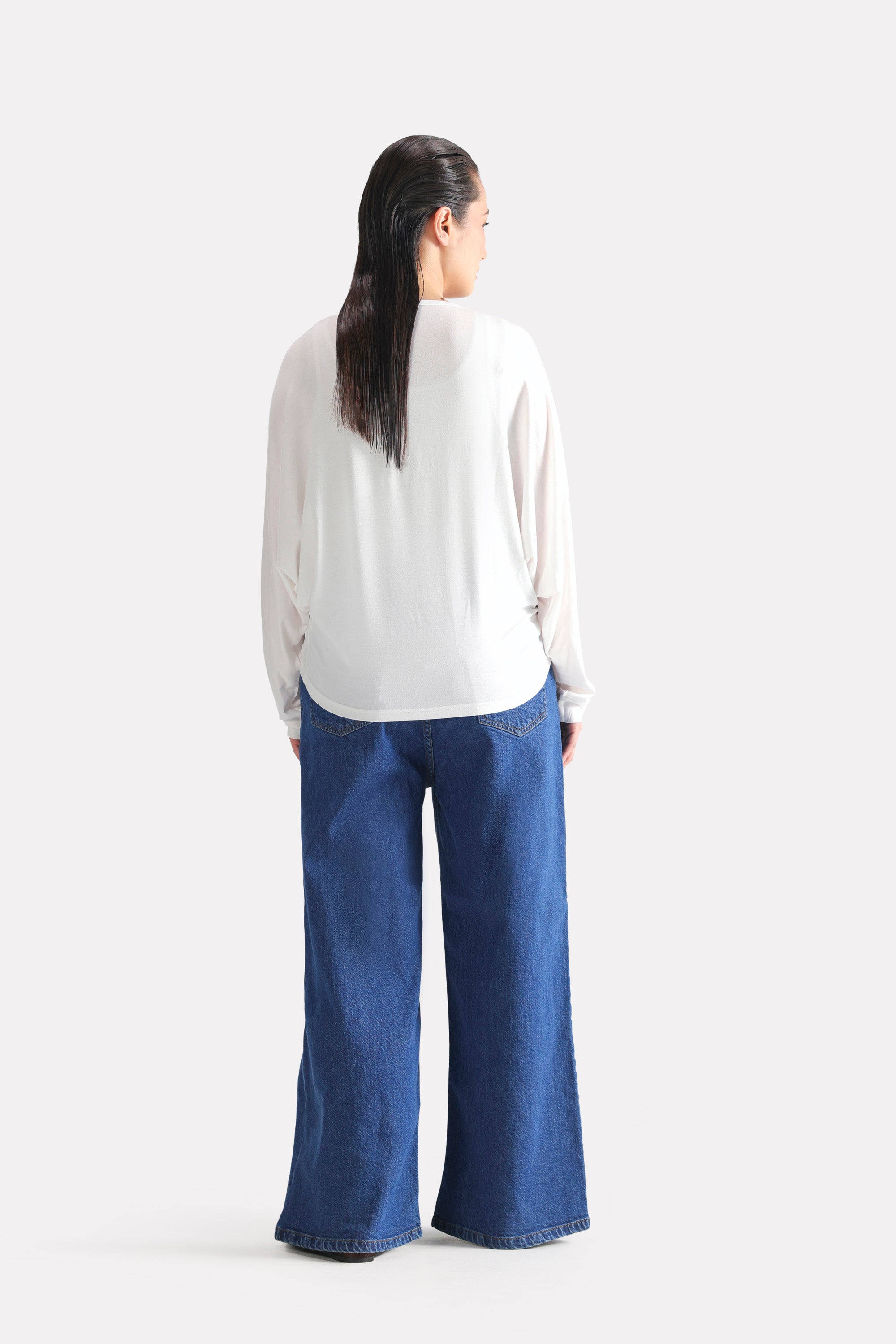 Flat lay of the white fluid sleeve t-shirt, by SOLA Pakistan.