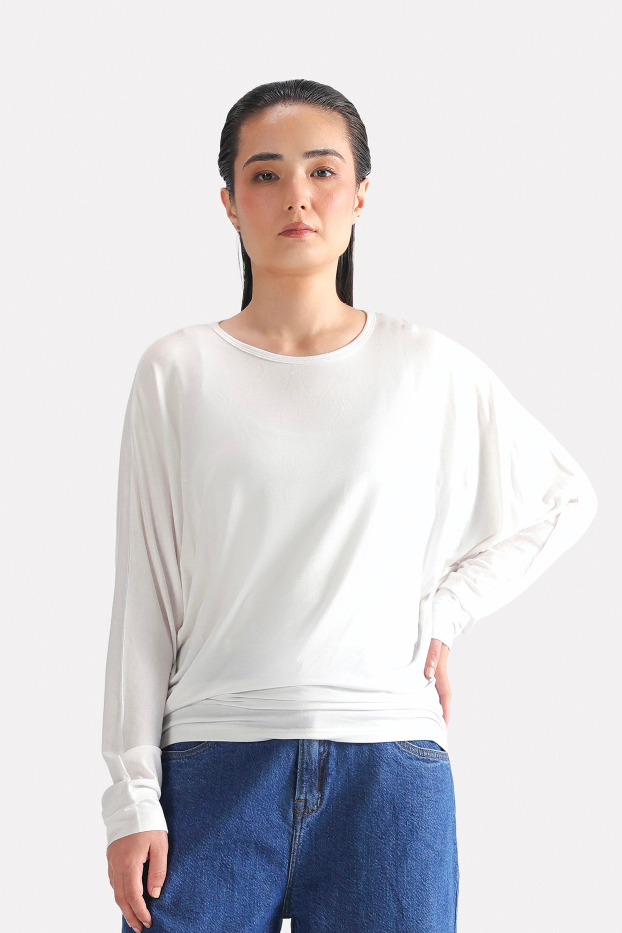 White fluid sleeve t-shirt in modal, worn by a model, by SOLA Pakistan.