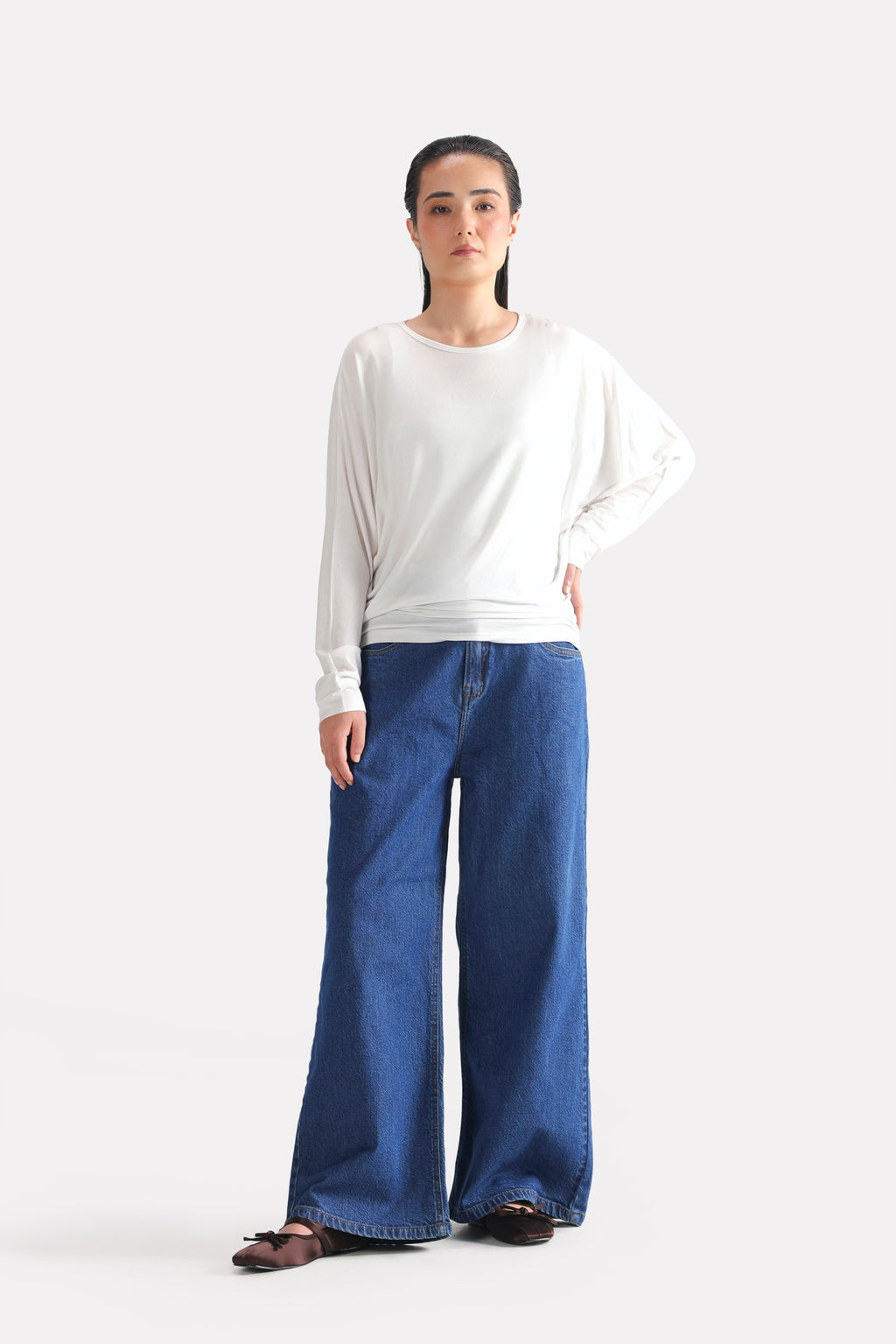 White fluid sleeve t-shirt shown in a styled fit, by SOLA Pakistan.