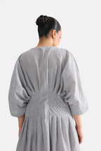 White & grey cinched waist seersucker dress shown in a styled fit, by SOLA Pakistan.