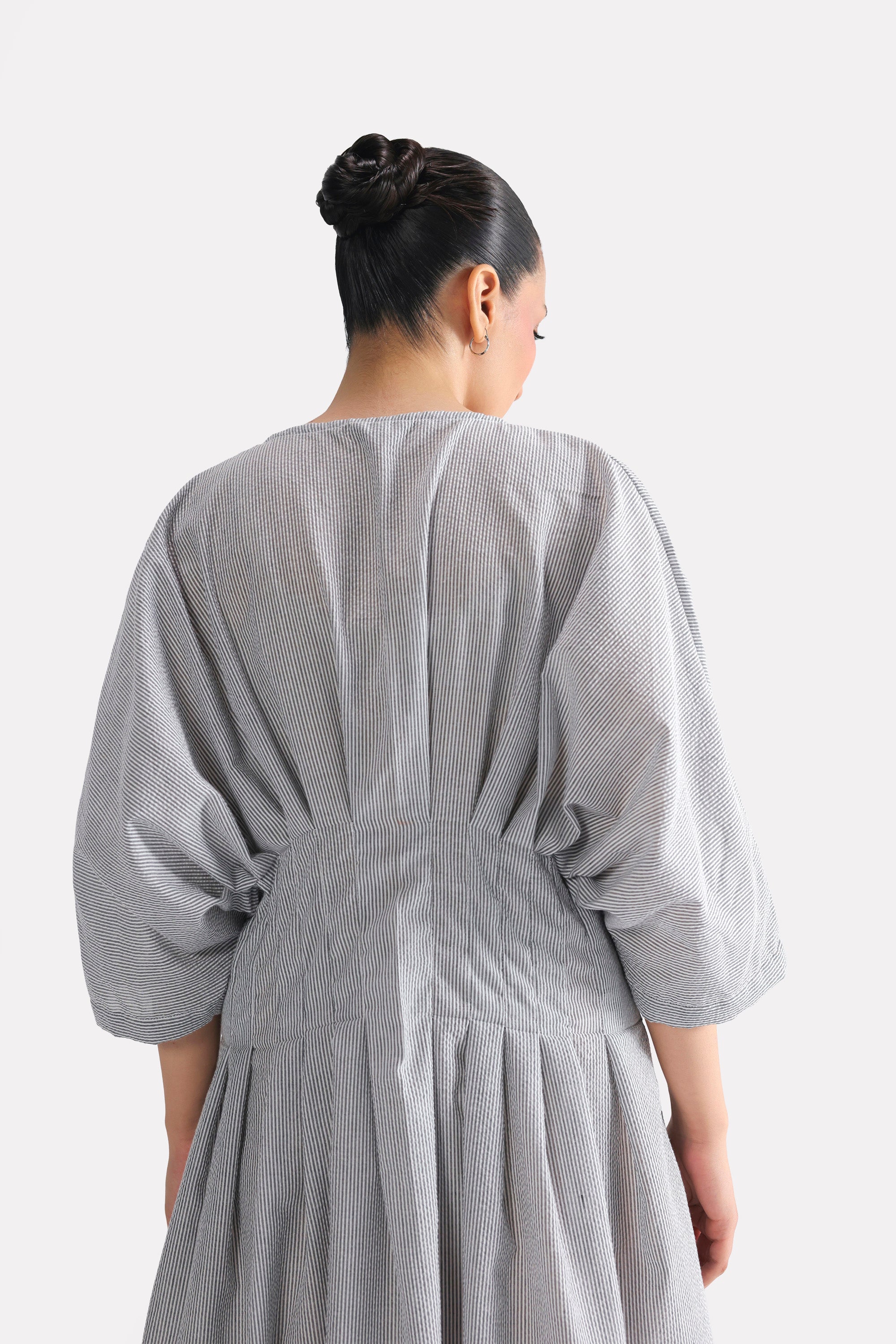 White & grey cinched waist seersucker dress shown in a styled fit, by SOLA Pakistan.