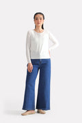 White henley t-shirt in modal, worn by a model, by SOLA Pakistan.