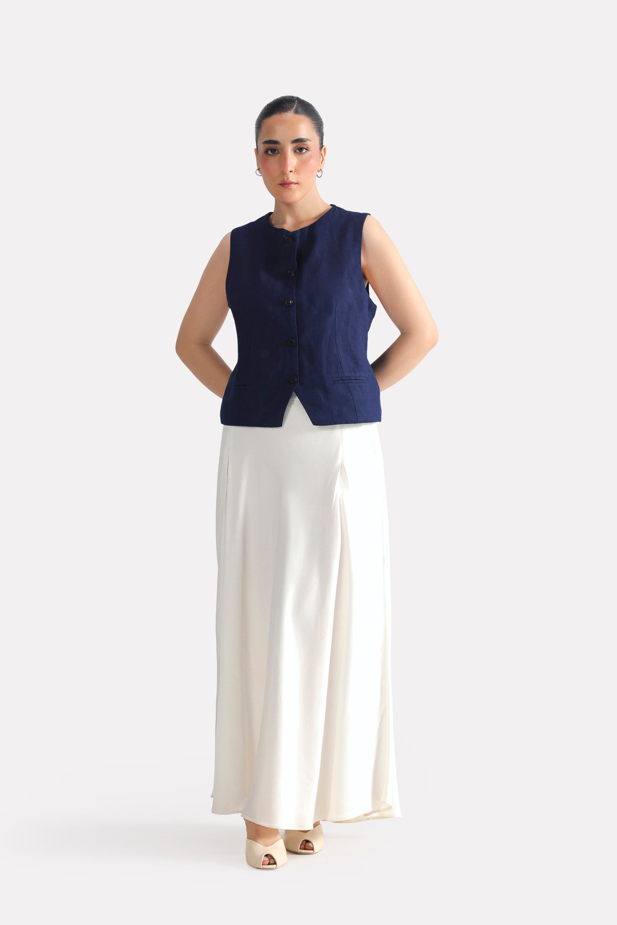 White satin silk skirt, worn by a model, by SOLA Pakistan.