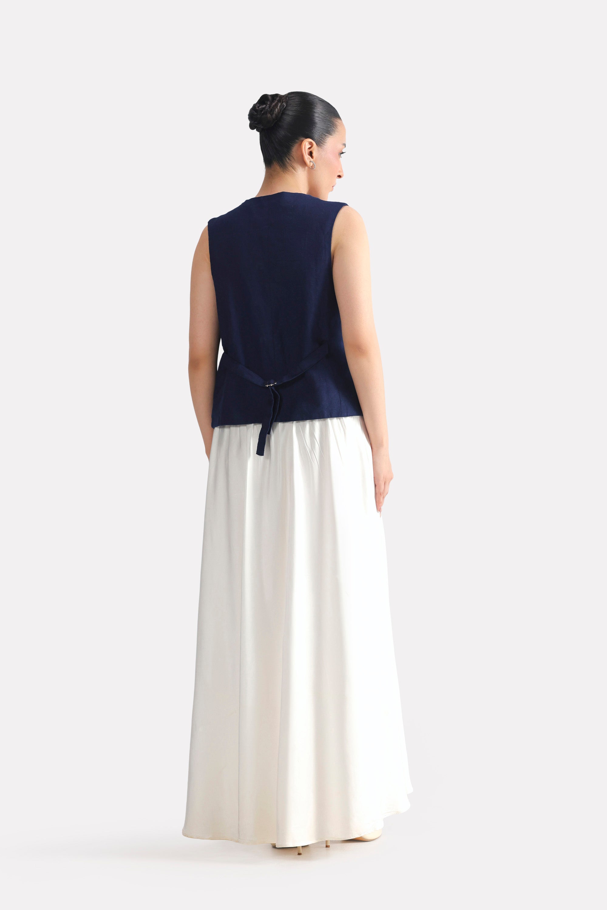 White satin silk skirt shown in a styled fit, by SOLA Pakistan.