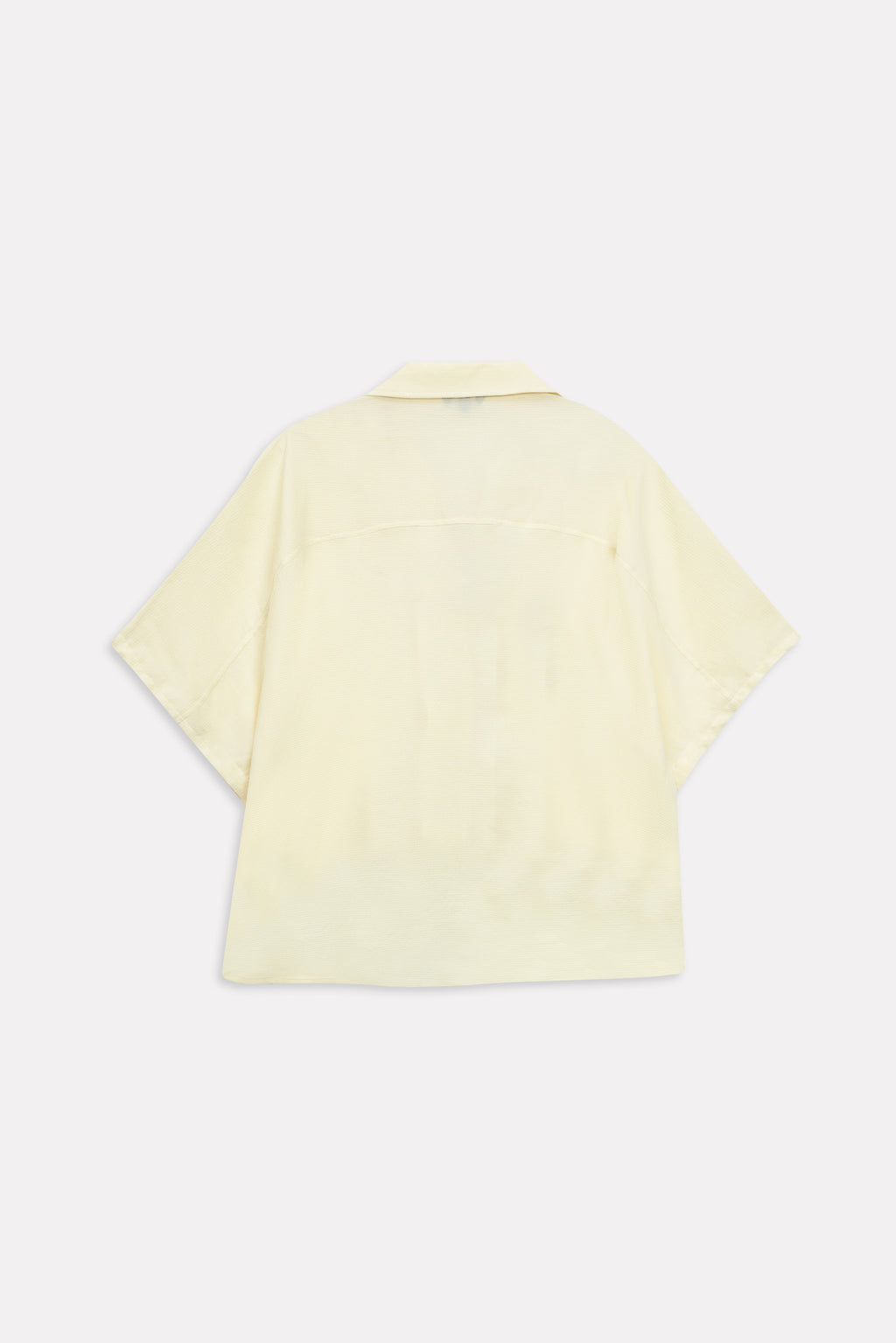 Flat lay of the yellow bubble hem oversized top, by SOLA Pakistan.