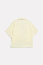 Flat lay of the yellow bubble hem oversized top, by SOLA Pakistan.
