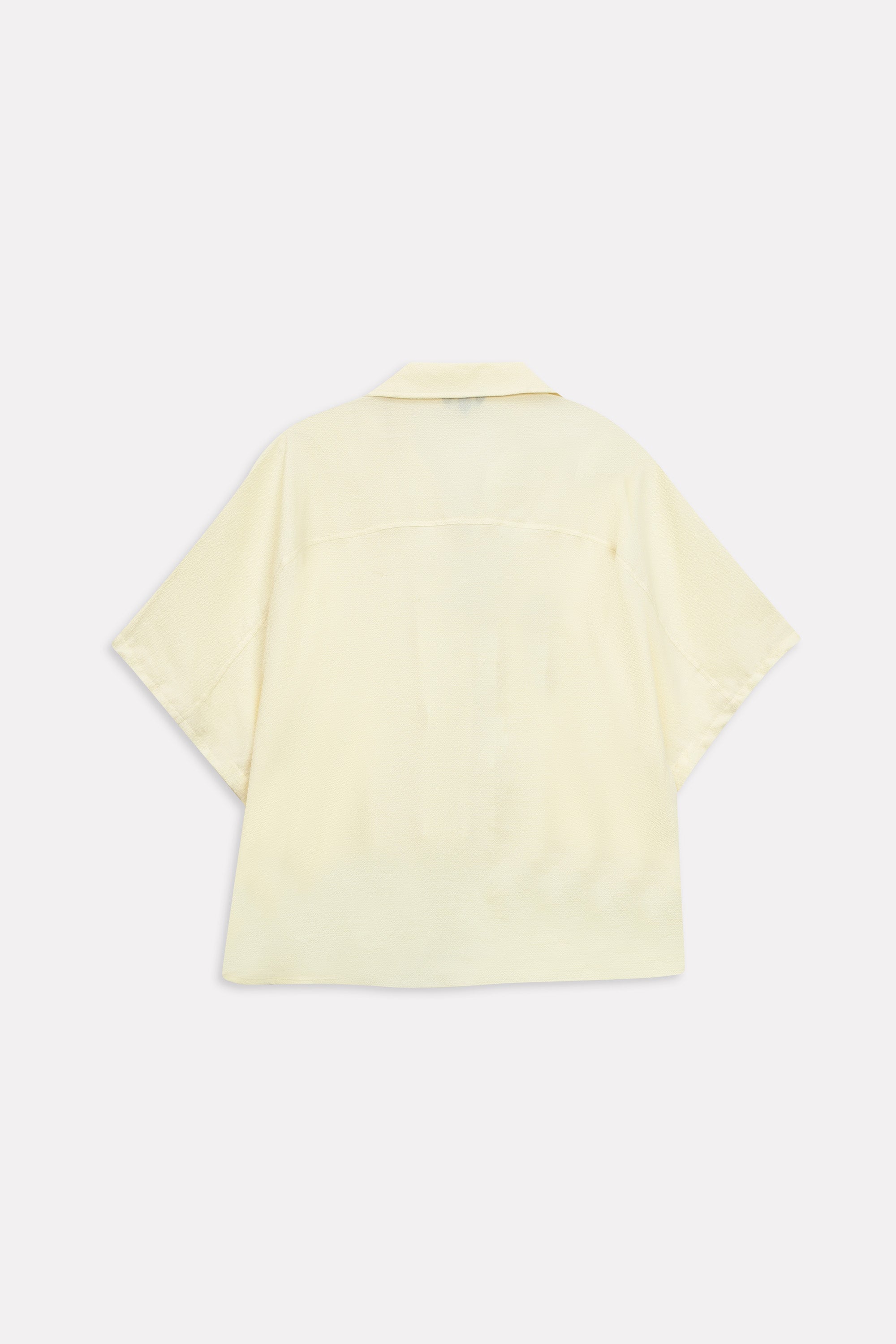 Flat lay of the yellow bubble hem oversized top, by SOLA Pakistan.