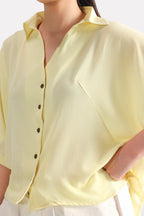 Texture and fabric detail, yellow bubble hem oversized top, by SOLA Pakistan.